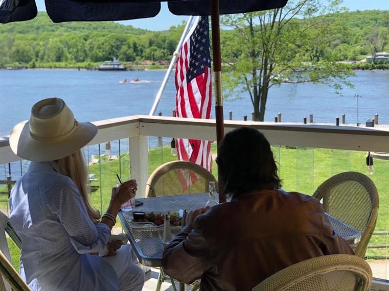 two people enjoying a meal on the outside patio